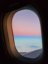 Aerial view of sea seen through airplane window