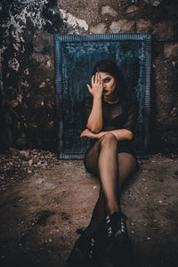 Woman sitting in abandoned room