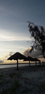 Scenic view of beach against sky during sunset