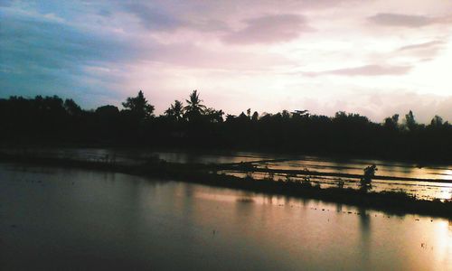 Scenic view of lake at sunset