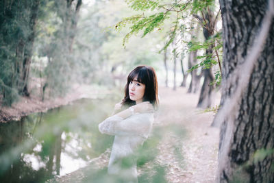 Portrait of woman standing in forest