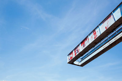 Low angle view of abandoned metal structure against sky