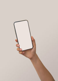 Low angle view of person using smart phone against white background