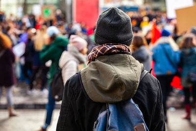 Rear view of people standing on street