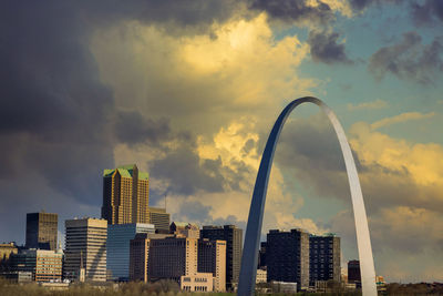 Low angle view of buildings against cloudy sky