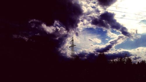 Low angle view of silhouette trees against sky