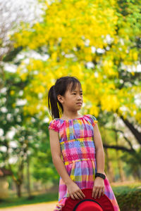 Full length of cute girl against trees