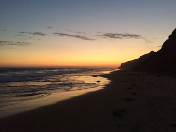 View of beach at sunset