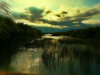 Scenic view of lake against cloudy sky