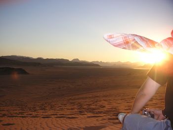 Scenic view of desert against sky during sunset