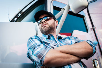 Midsection of man sitting in car