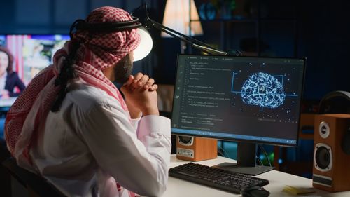 Rear view of people working at office