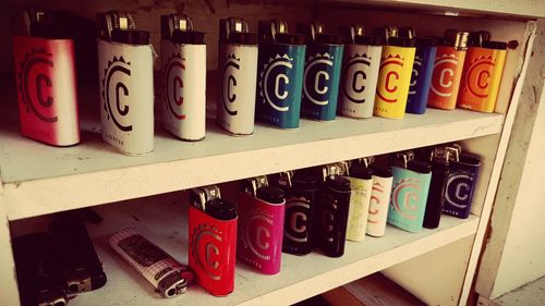 Close-up of multi colored bottles on shelf