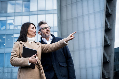 Portrait of smiling couple standing in city