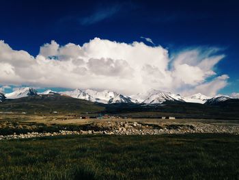 Scenic view of snowcapped field against sky