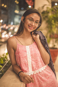 Portrait of smiling young woman standing outdoors