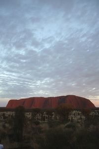 Scenic view of landscape against cloudy sky
