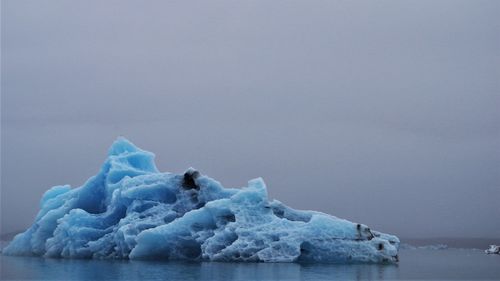 Frozen sea against sky