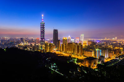 Illuminated buildings in city at night