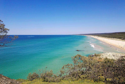 Scenic view of sea against clear blue sky