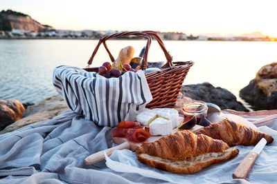 Close-up of breads in basket on beach