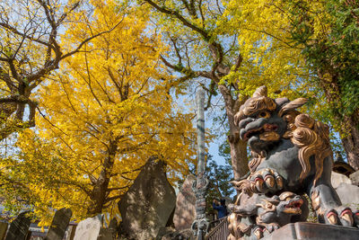 Statue against trees during autumn