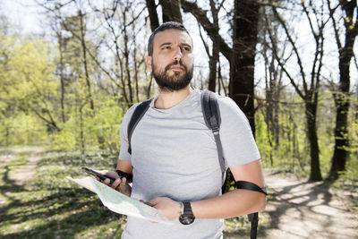 Young man standing in forest