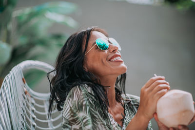 Portrait of a smiling young woman looking away