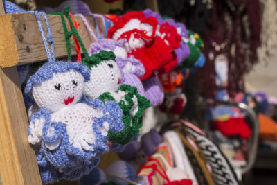 Colorful handmade knitted dolls at different colors in souvenir market