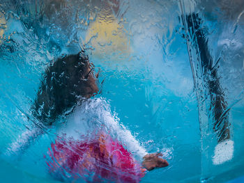 Boy swimming in pool