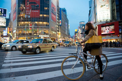 Man riding bicycle on city street