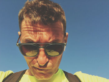 Portrait of man wearing sunglasses against clear sky