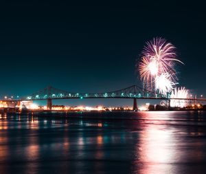 Firework display over river at night