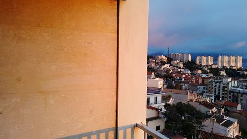 City against cloudy sky seen from balcony