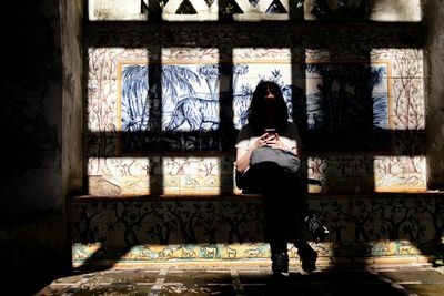 Rear view of woman photographing