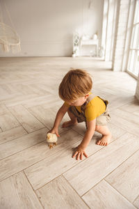 Boy playing with ducks for easter