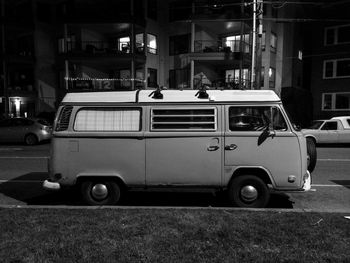 Micro bus parked in front of building at night