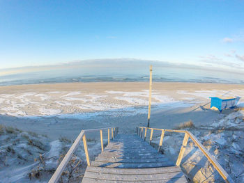 Scenic view of beach against clear blue sky