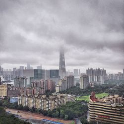 Cityscape against cloudy sky