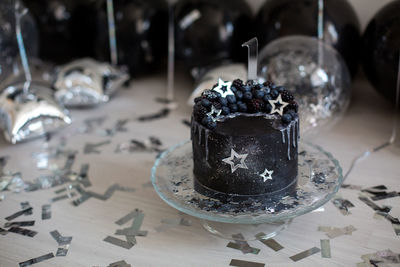 Black cake with stars and berries with the number one