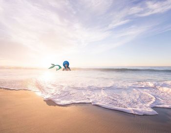 Man surfing in sea against sky