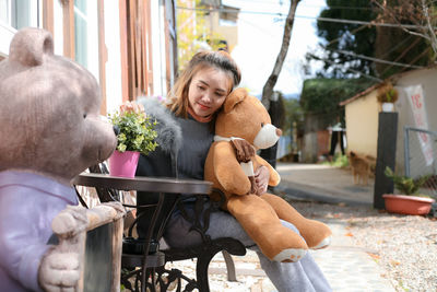 Woman sitting by toy car