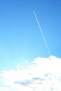 Low angle view of vapor trail in blue sky