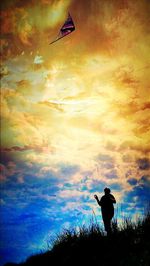 Low angle view of person against cloudy sky