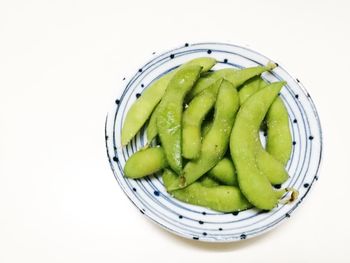 High angle view of fruit in bowl against white background