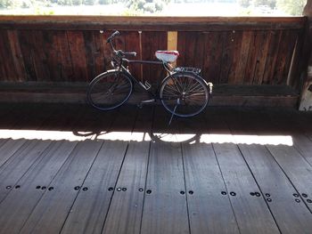 Bicycle parked on wooden wall