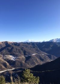 Scenic view of mountains against clear blue sky