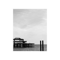 Lifeguard hut by sea against sky