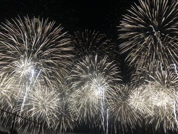 Low angle view of firework display at night