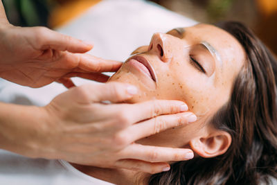 Woman with skincare face mask in beauty salon